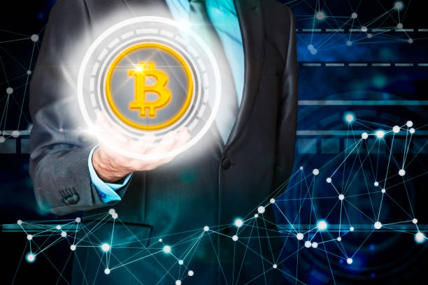 istock Businessman holding a virtual bitcoin. 1065050622