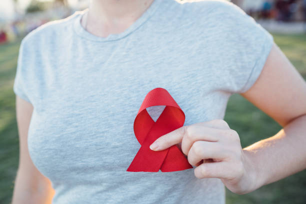 istock Hands holding red AIDS awareness ribbon 1065054232