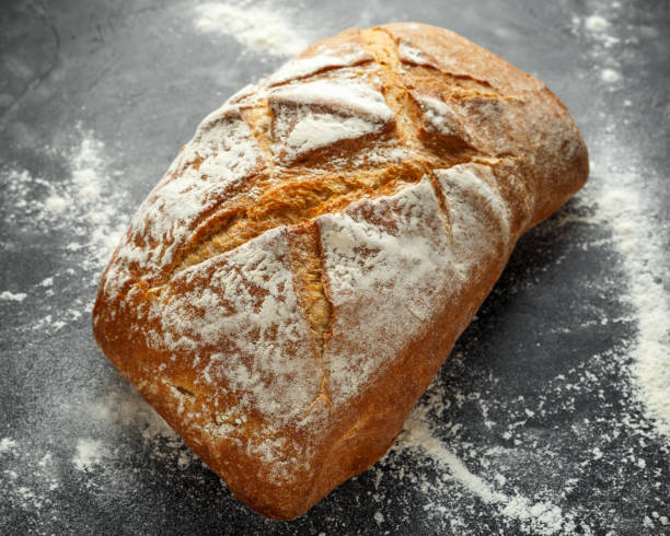 istock freshly baked sourdough bread on black background 1065060350