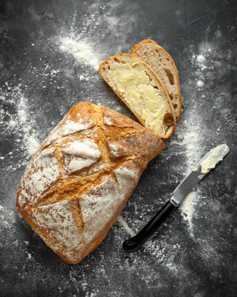 istock freshly baked sourdough bread and two slices with butter 1065060378