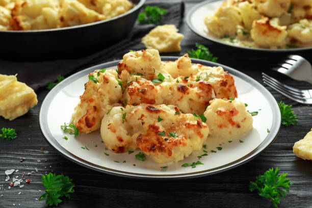 istock Roasted cauliflower with cheddar cheese sauce and herbs. 1065061252