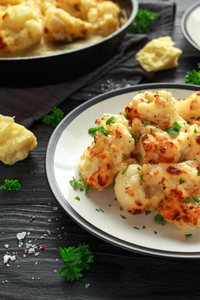 istock Roasted cauliflower with cheddar cheese sauce and herbs. 1065061828
