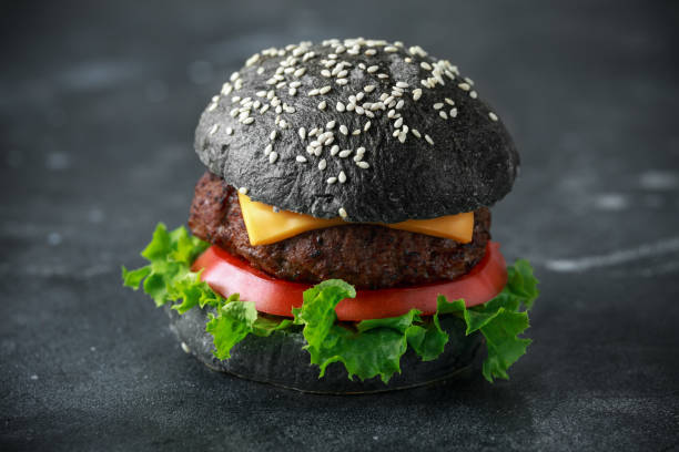 istock Homemade Beef Burger with black bun, tomato, lettuce and cheese 1065062830