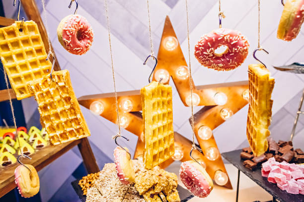 istock Waffles and donuts hanging on the ropes in the buffet 1065072876