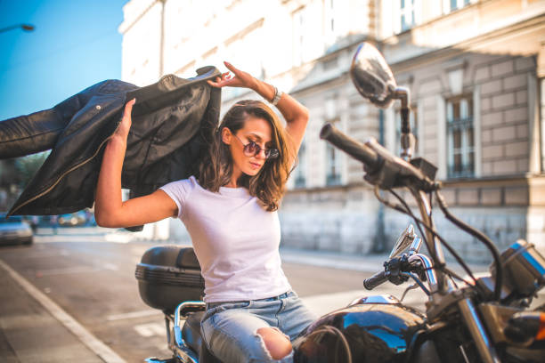 istock Young pretty fashioned girl sitting on her motorcycle 1065083626