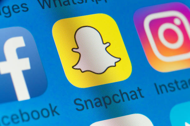 Snapchat, Facebook, Instagram and other cellphone Apps on iPhone screen stock photo