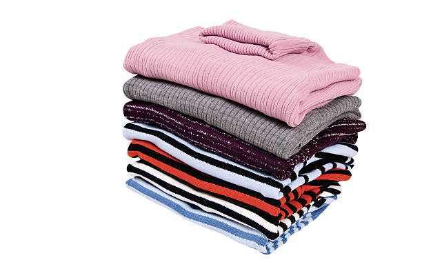 istock Stack of colorful winter sweaters isolated on a white. 106508576