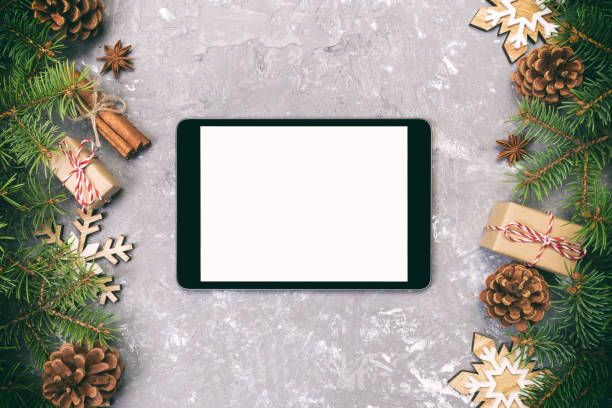 istock Digital tablet mock up with rustic Christmas gray cement rustic vintage background decorations for app presentation. top view with copy space 1065086714