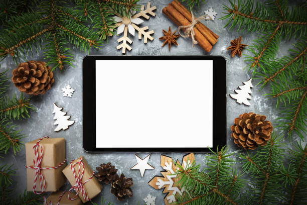 istock Digital tablet mock up with rustic Christmas gray cement rustic vintage background decorations for app presentation. top view with copy space 1065086716