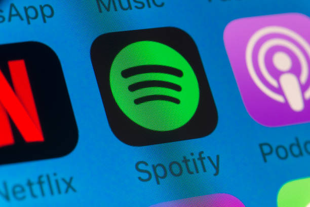 Spotify, Podcasts, Netflix and other cellphone Apps on iPhone screen London, UK - August 01, 2018: The buttons of Spotify, Podcasts, Netflix, WhatsApp and Music on the screen of an iPhone. britain british audio stock pictures, royalty-free photos & images