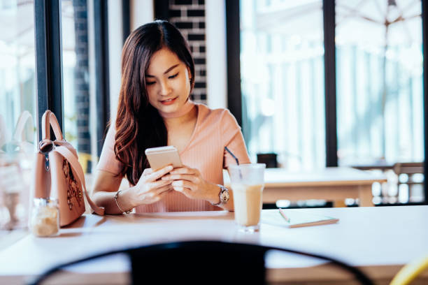 istock Malaysian businesswoman using phone in cafe 1065107818