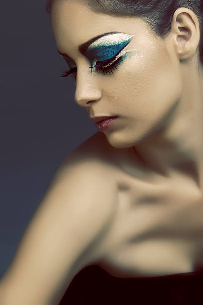 istock beautiful woman with artistic turquoise eye make-up 106510861