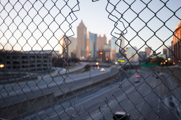 istock City skyline through the wire mesh fence 1065111436