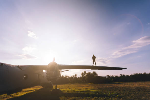 istock Man standing on a abandoned airplane wing 1065117198