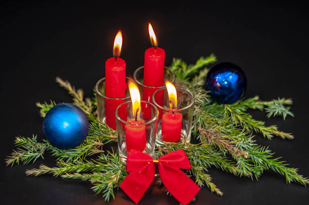 istock Christmas candles on a black background 1065119474