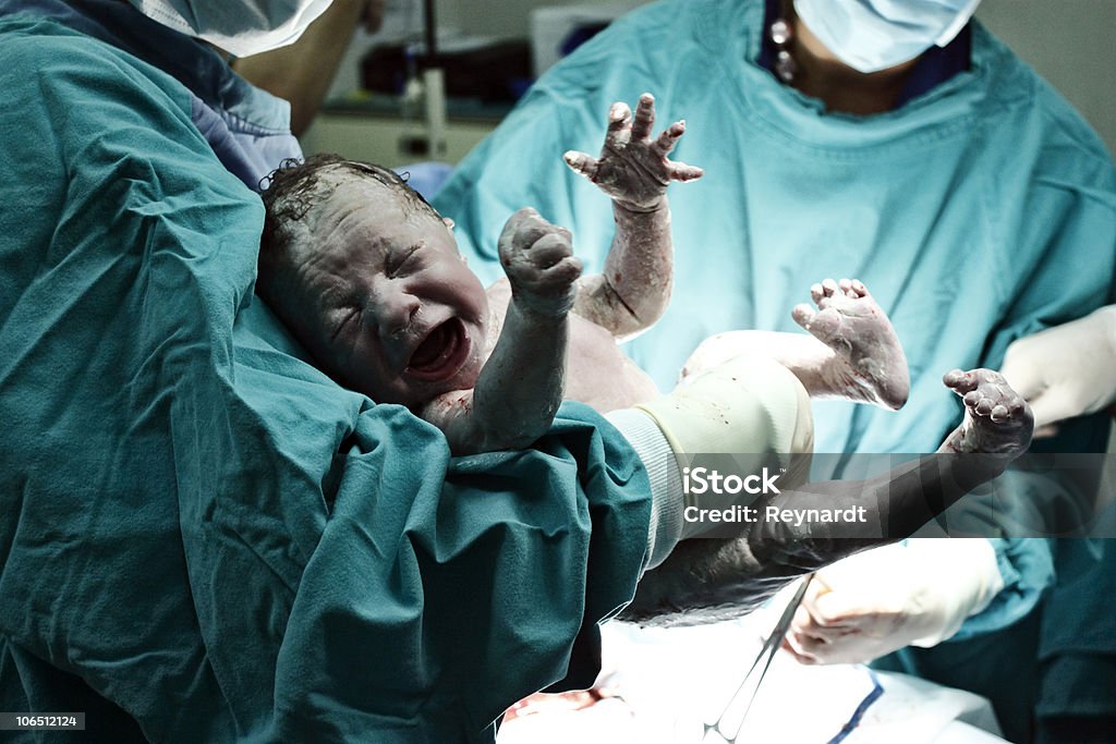 Doctor holding new born  Childbirth Stock Photo