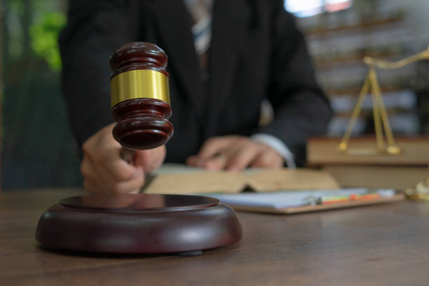 Caucasian lawyer signing documents in office