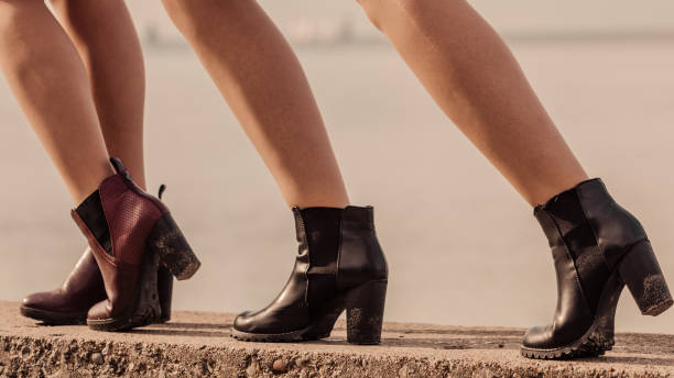 istock Three women presenting shoes outdoor 1065123982