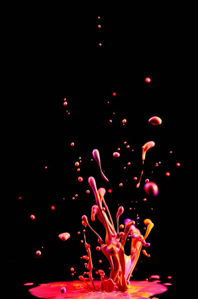 Dancing colored paint. Abstract sculpture dye. Splash of ink on a black background