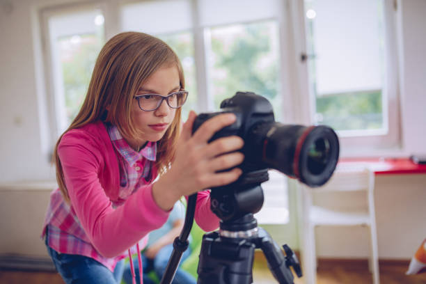 istock Cute girl photographer 1065128556