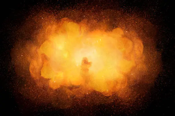 Photo of Realistic bomb explosion, orange color with sparks isolated on black background
