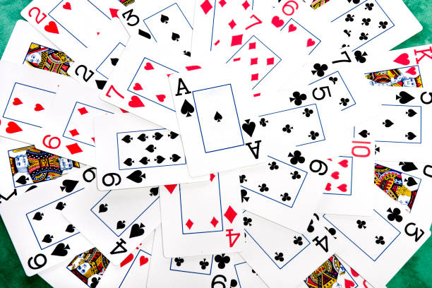 istock bunch cards spread on a green cloth table 1065139140