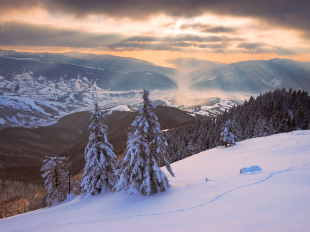 istock Sun rays over the mountains valley in winter 1065143514