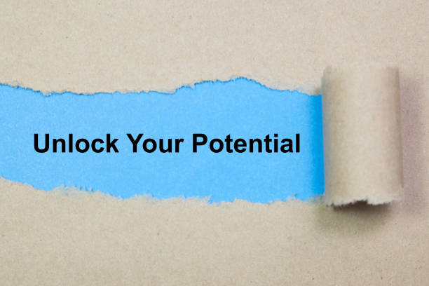 istock unlock your potential text on paper. Word unlock your potential on torn paper. Concept Image. 1065143642