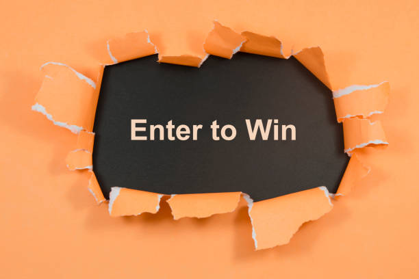 istock Enter to win text on paper. Word Enter to win on torn paper. Concept Image. 1065143794