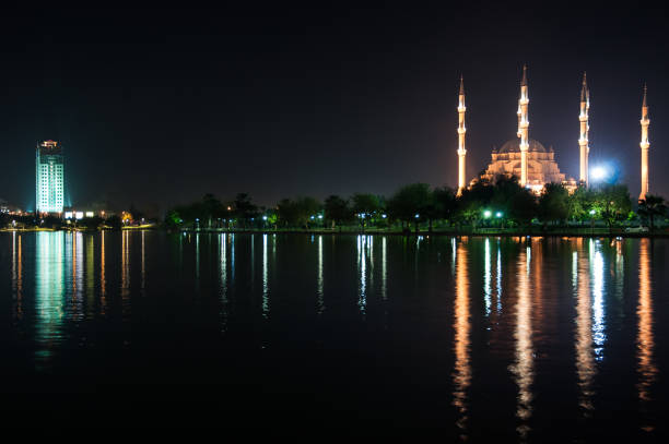 istock The view mosque and reflection at night, city background. 1065143840