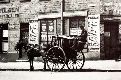 Sydney, Australia - 1924: Detail of old photo from 1924 of horse carriage with rider standing on street of Sydney Australia