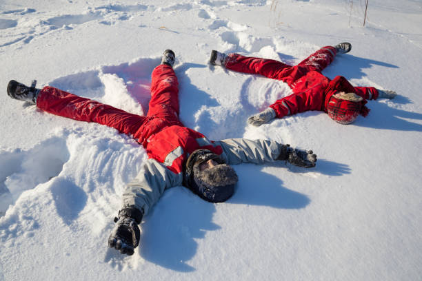 istock Two boys sitting at the snow on park 1065147456