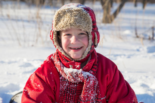 istock Adorable smiling boy at the snow background 1065147464