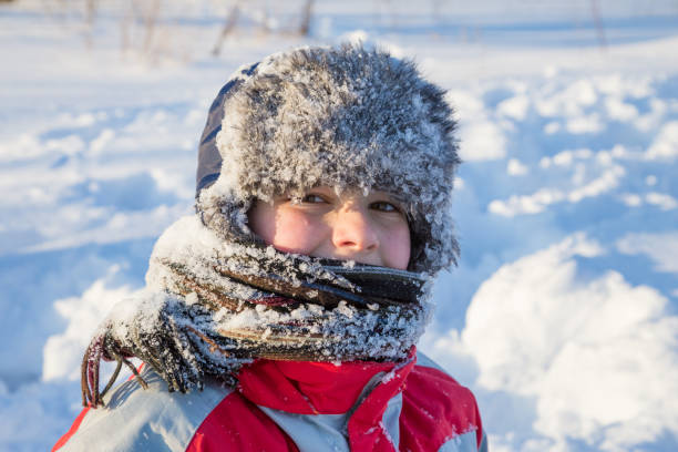 istock Adorable smiling boy at the snow background 1065147476