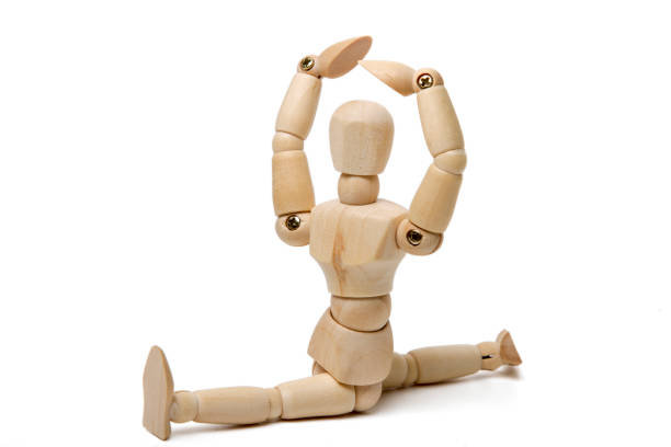 istock wooden dummy doing gym poses 1065148848