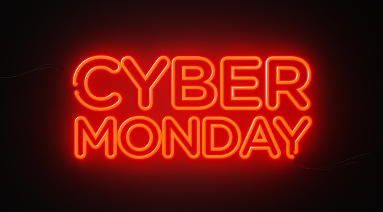 Cyber Monday red neon light on black wall. Horizontal composition with copy space. Cyber Monday concept.