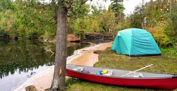 istock campsite with tent and canoe 1065159792