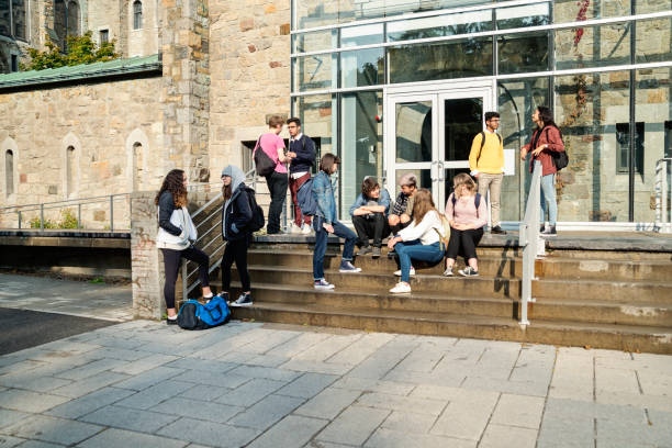 istock Multi-ethnic group of students taking a break in front of College doors. 1065166094