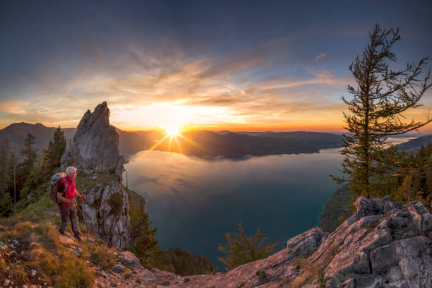 istock Mountain Climber at sunset with View To Lake Attersee from Schober- Sunset at Mount Schoberstein, Alps 1065169730