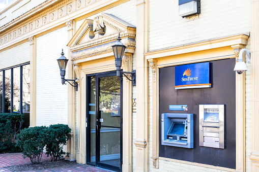 Washington DC, USA - March 9, 2018: Suntrust bank, banking branch, office building entrance at Dupont Circle, no people, nobody, ATM, depository slot, door