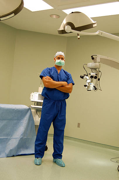 Masked surgeon in operating room stock photo