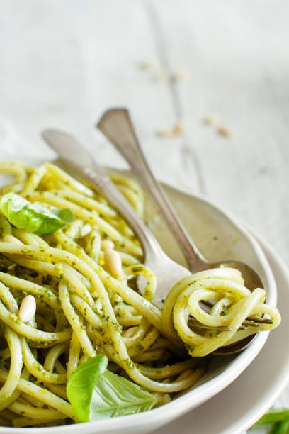 istock Spaghetti pasta with pesto sauce 1065175238