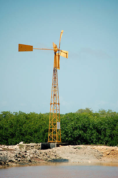 Yellow windmill on vertical landscape stock photo