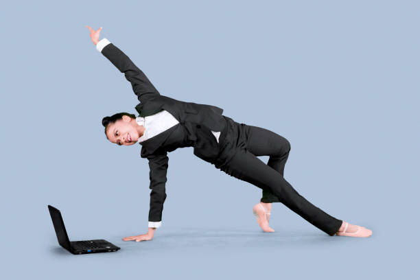 istock Asian businesswoman dancing with laptop on studio 1065175732