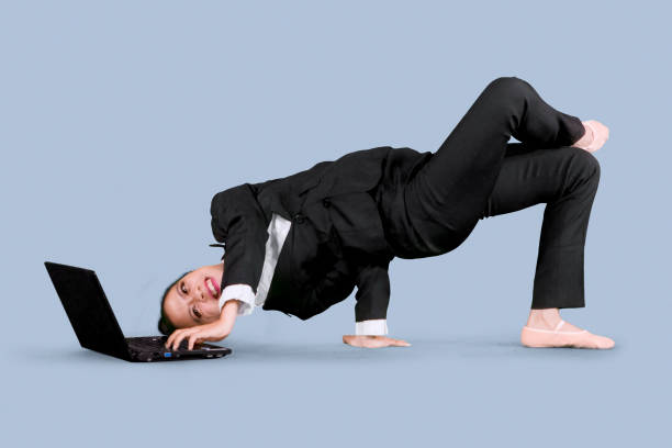 istock Businesswoman using a laptop with dance pose 1065175766