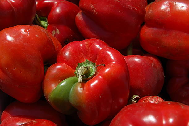 fresh red peppers close up stock photo