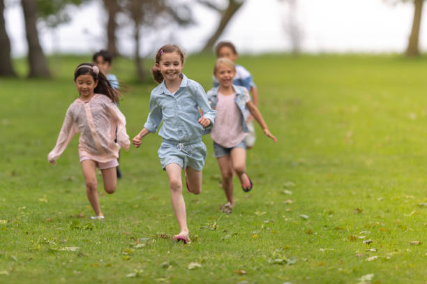 istock Laughing children run through a park 1065178984