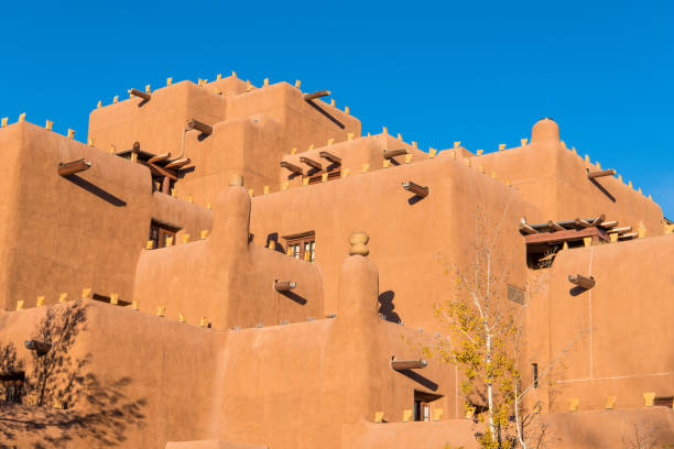 istock Pueblo style adobe building in Santa Fe, New Mexico in warm evening light under a bright blue sky 1065183492