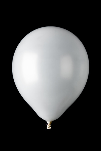 A single white helium-filled balloon on black background
