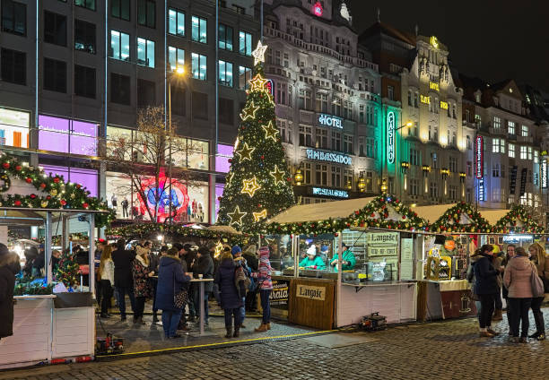 Christmas market at Wenceslas Square in Prague, Czech Republic Prague, Czech Republic - December 5, 2017: Christmas market at the Wenceslas Square in night. The market offers the variety of food and beverages. Unknown people eat street food. prague christmas market stock pictures, royalty-free photos & images